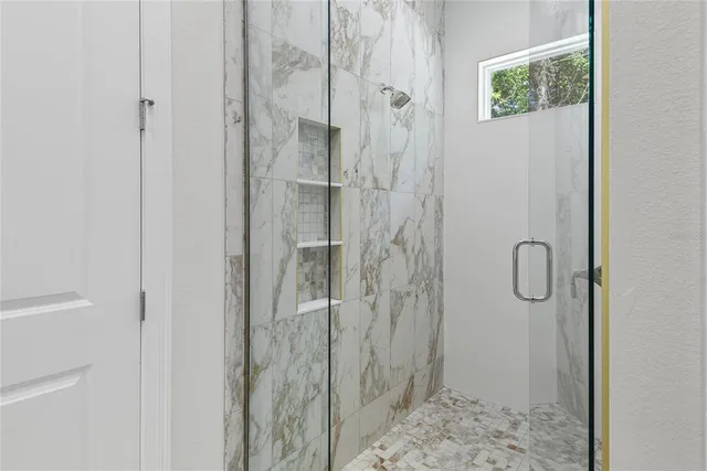 a bathroom with a glass shower door