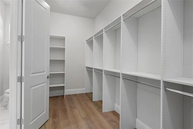 a view of walk in closet with empty racks