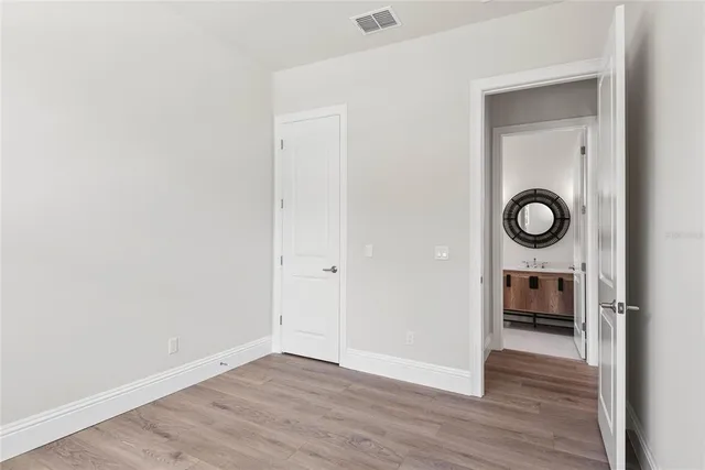 a view of an empty room with a gallery and wooden floor