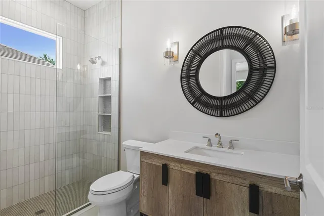 a bathroom with a sink a toilet and a mirror