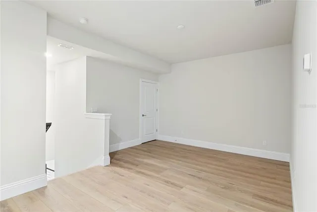 an empty room with wooden floor