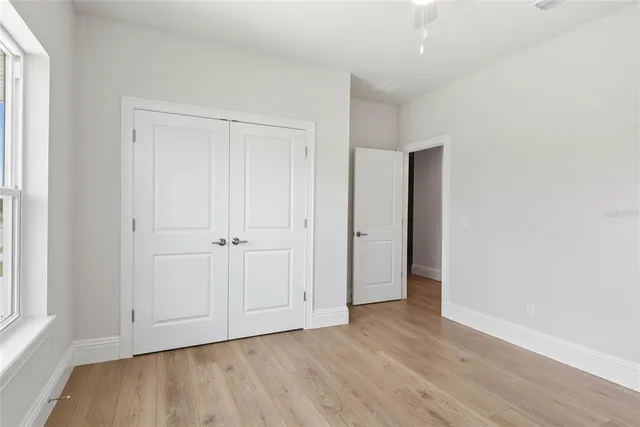 a view of an empty room and wooden floor