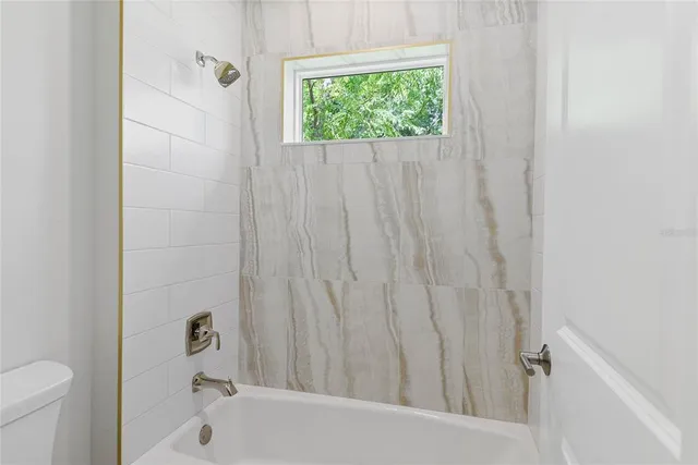 a bathroom with a bathtub and shower