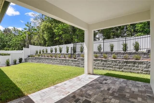 a view of a garden with wooden fence