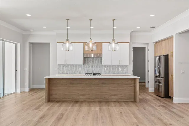a view of a kitchen with stainless steel appliances granite countertop cabinets and wooden floor
