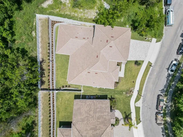 an aerial view of a house with fountain and large windows