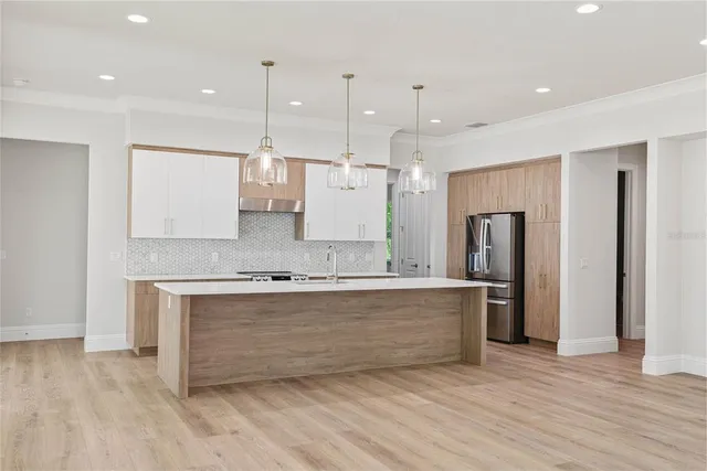 a large kitchen with stainless steel appliances kitchen island a large island in the center