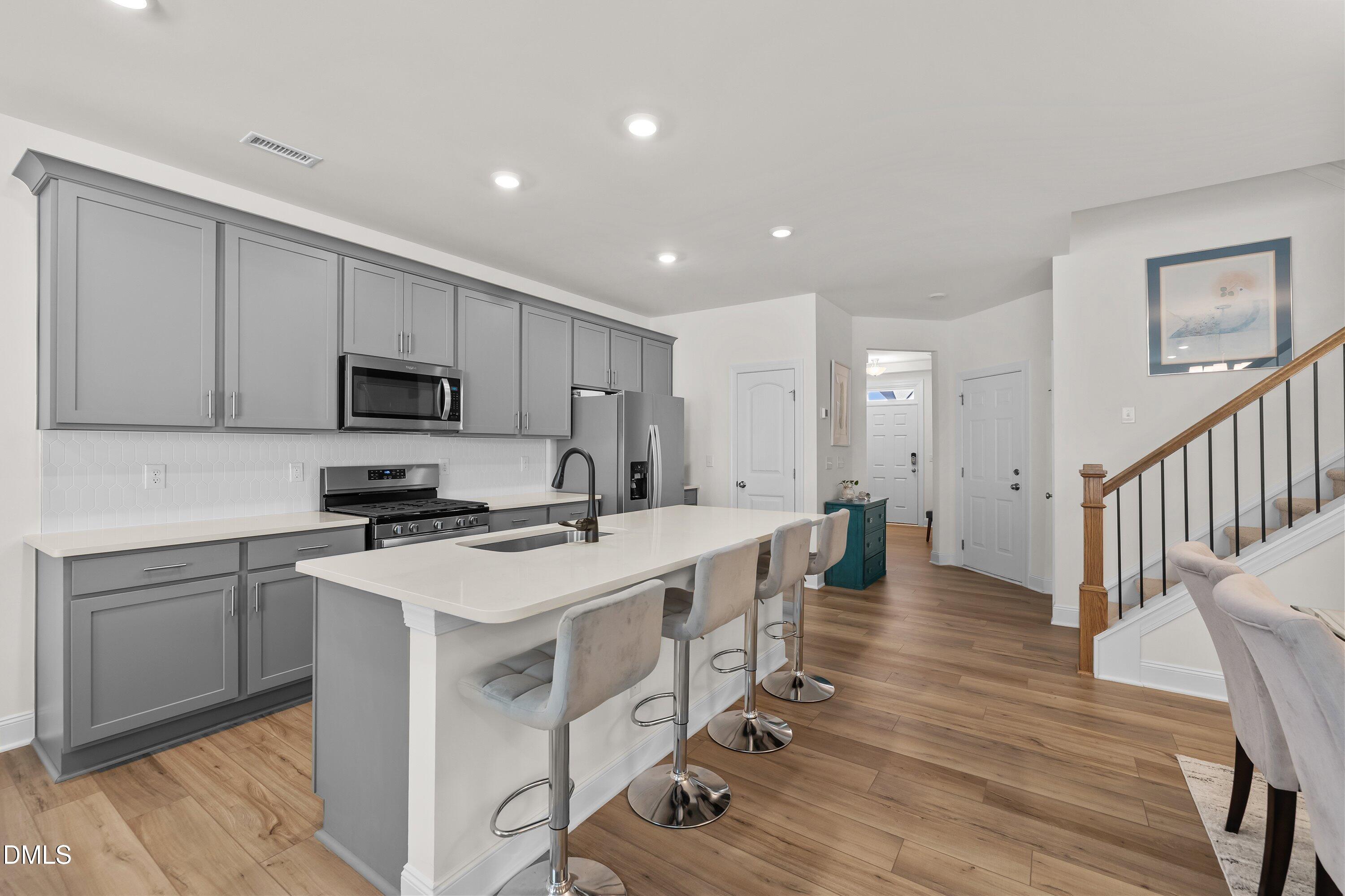 1014 Culloden Circle Durham, NC 27713 - Photo 11 of 32 a kitchen with appliances a sink a stove a table and chairs
