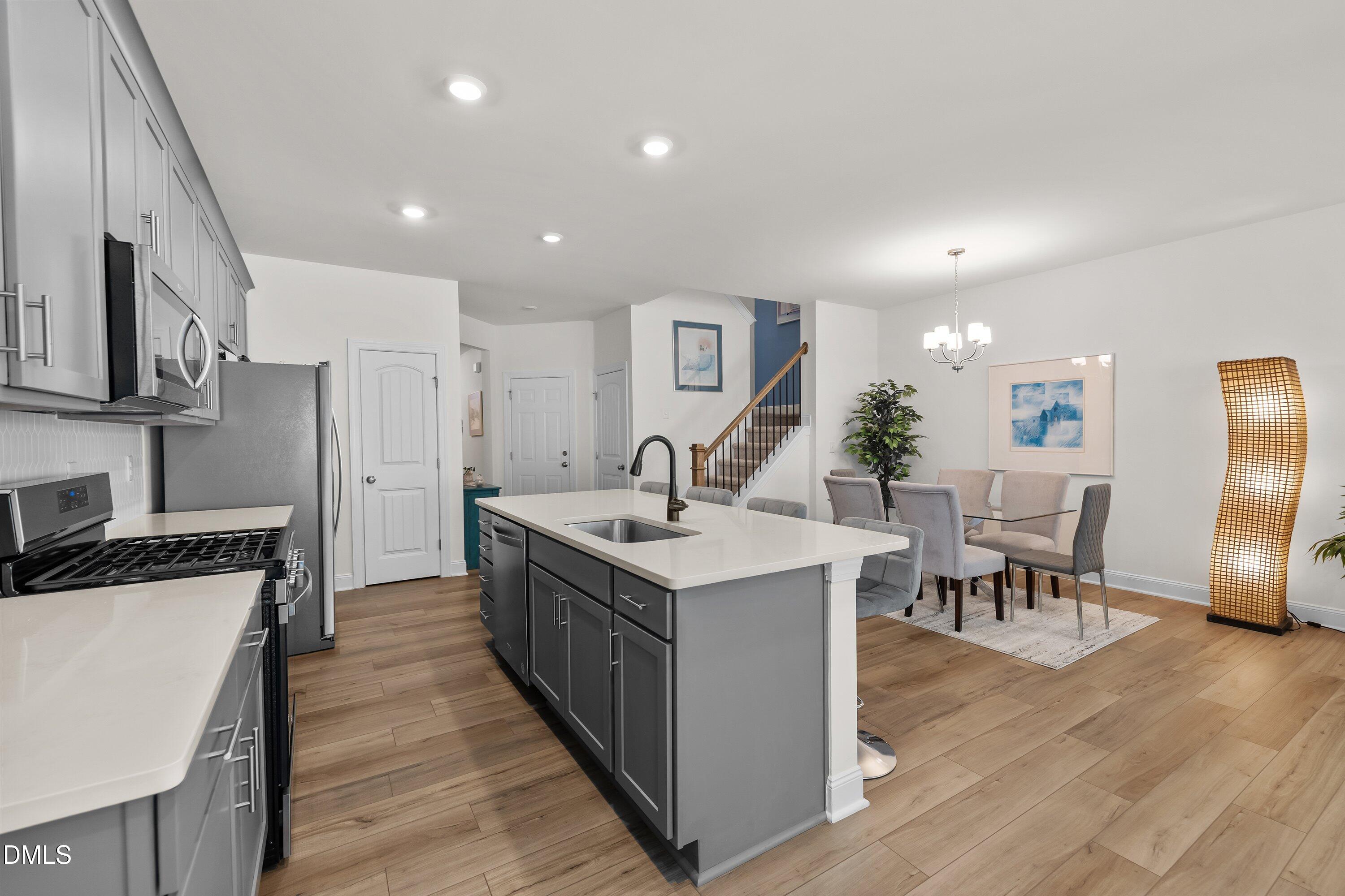 1014 Culloden Circle Durham, NC 27713 - Photo 14 of 32 a kitchen with stainless steel appliances granite countertop a table and chairs in it