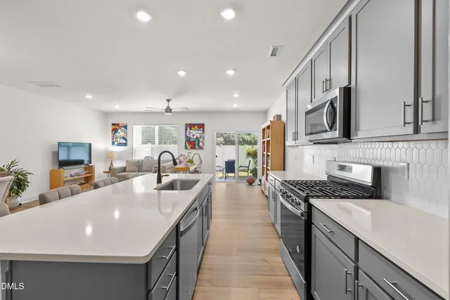 a large kitchen with kitchen island a sink counter space and stainless steel appliances