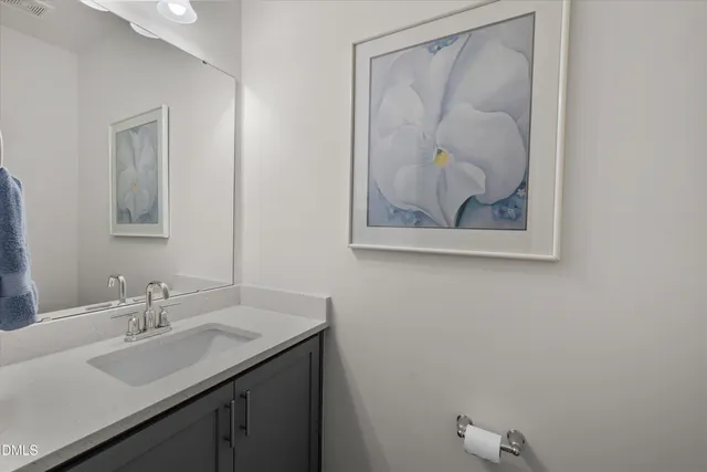 a bathroom with a sink vanity and a mirror