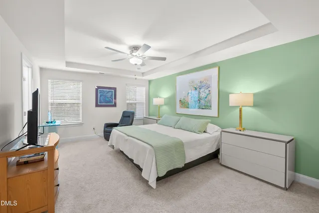 a bedroom with a bed wooden floor and window