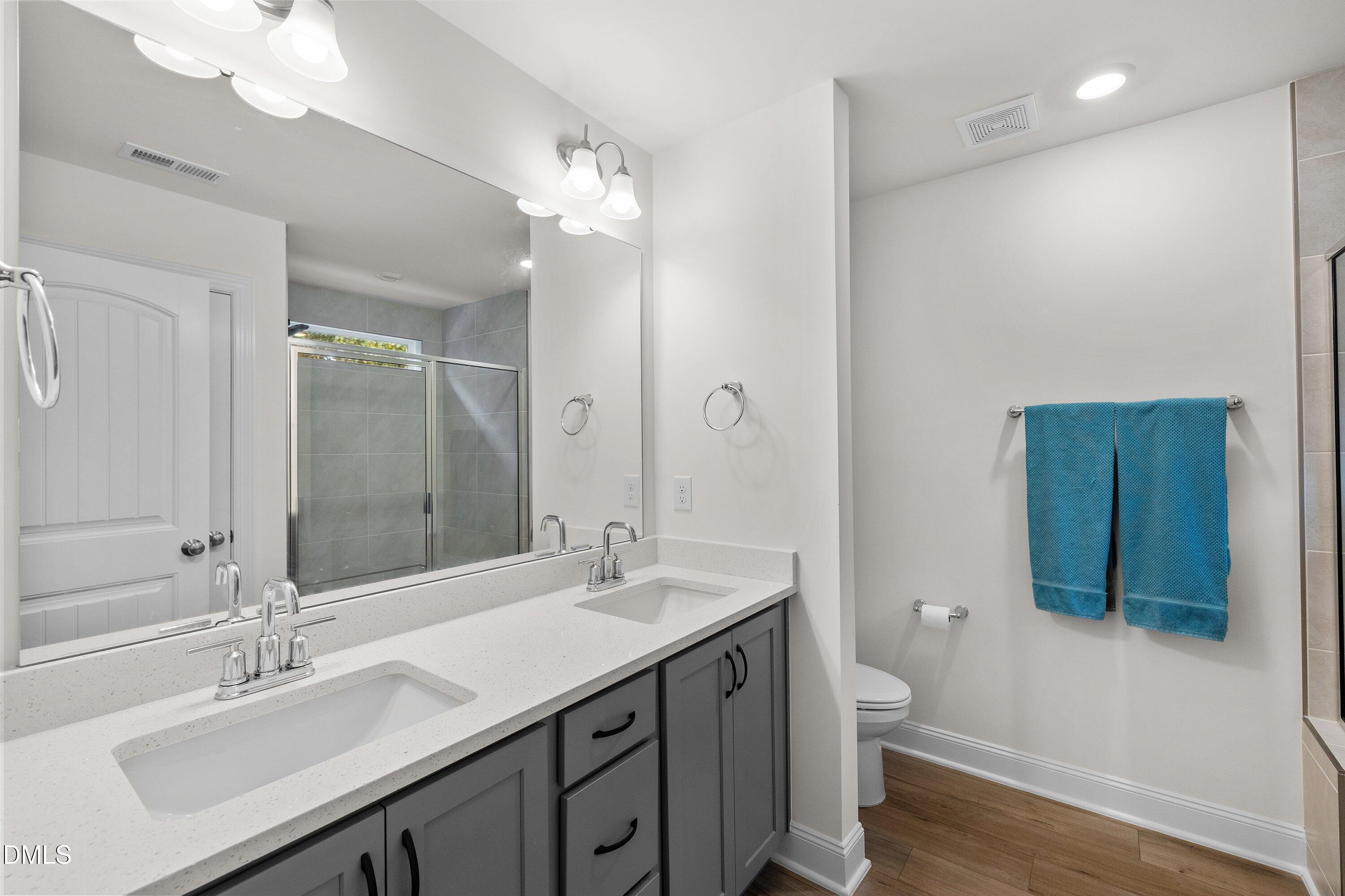 1014 Culloden Circle Durham, NC 27713 - Photo 20 of 32 a bathroom with a double vanity sink mirror and toilet