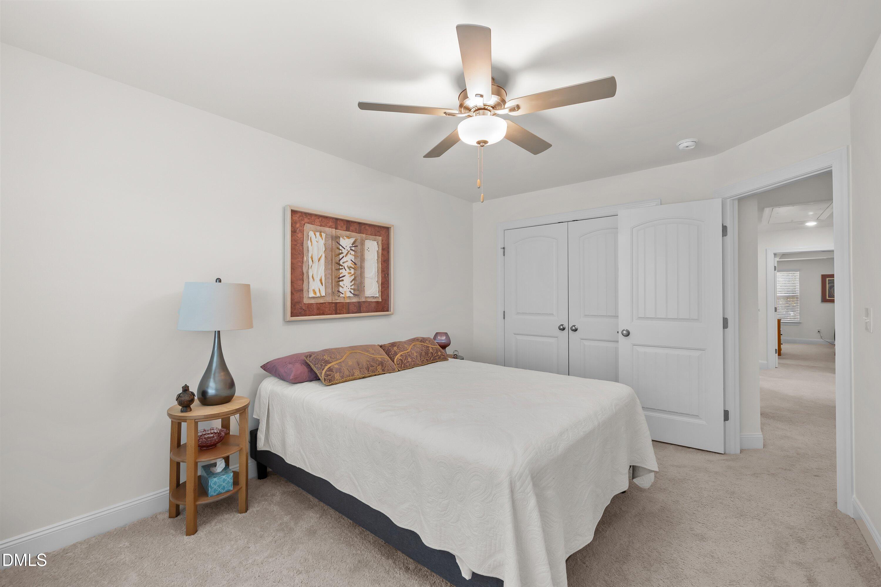 1014 Culloden Circle Durham, NC 27713 - Photo 23 of 32 a bedroom with a bed and a chandelier