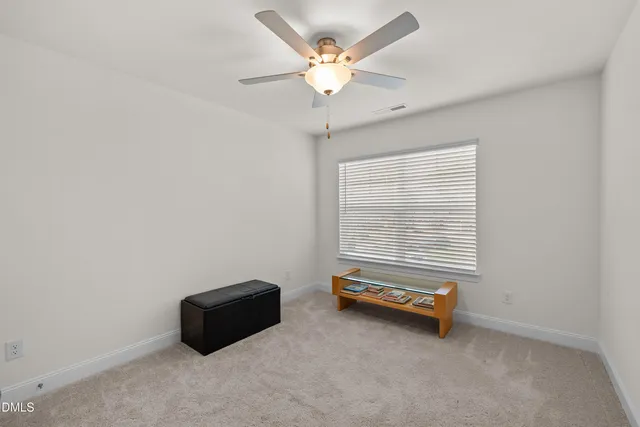 a room with a window and a ceiling fan