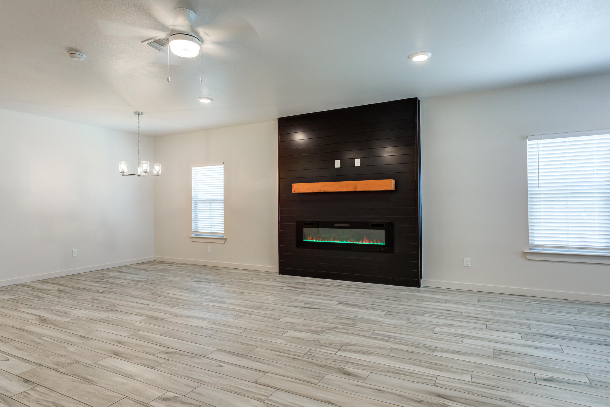 7046 41st Street Lubbock, TX 79407 - Photo 5 of 28 a view of empty room with wooden floor and fan