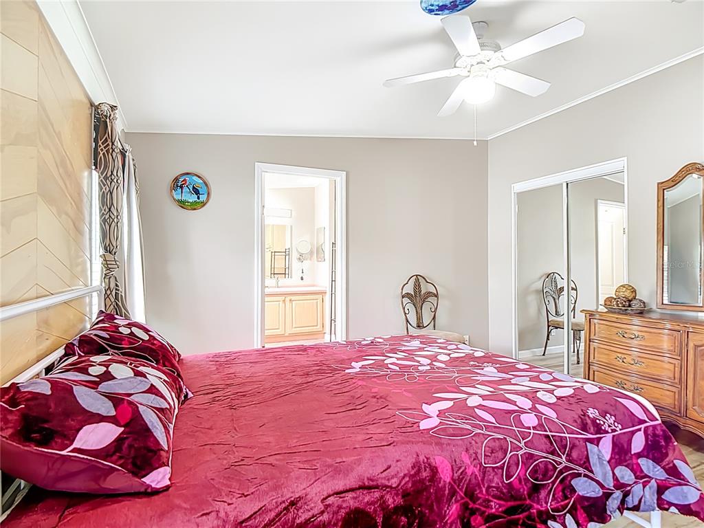 452 Par Drive Frostproof, FL 33843 - Photo 19 of 41 a bedroom with a bed and a chandelier