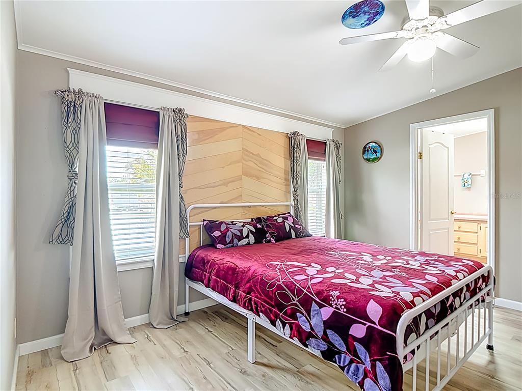 452 Par Drive Frostproof, FL 33843 - Photo 20 of 41 a bedroom with a bed and a chandelier