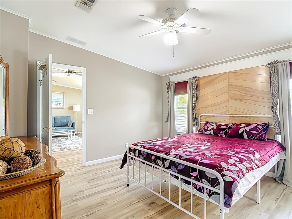 452 Par Drive Frostproof, FL 33843 - Photo 21 of 41 a bedroom with a bed and a chandelier
