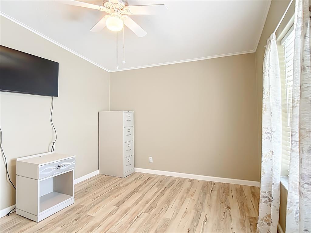452 Par Drive Frostproof, FL 33843 - Photo 27 of 41 a view of a livingroom with wooden floor and a flat screen tv