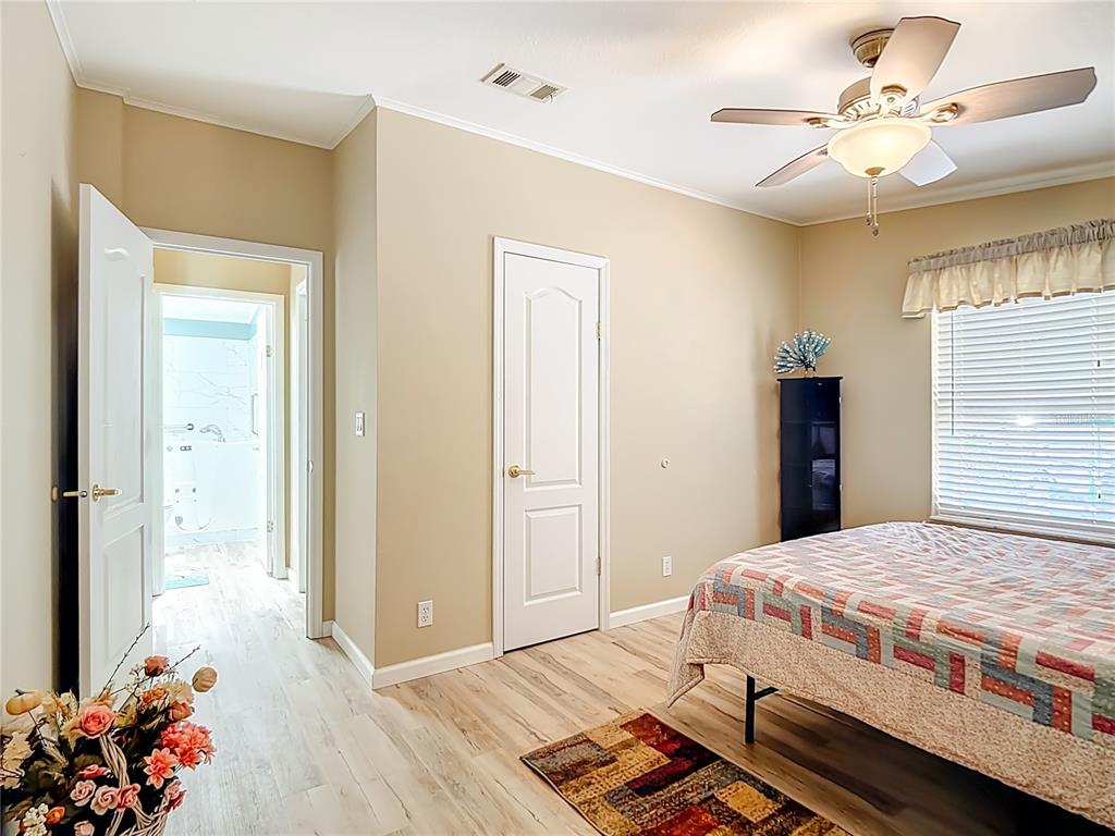 452 Par Drive Frostproof, FL 33843 - Photo 29 of 41 a bedroom with a bed and a chandelier