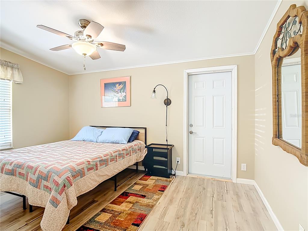 452 Par Drive Frostproof, FL 33843 - Photo 30 of 41 a bedroom with a large bed and a chandelier