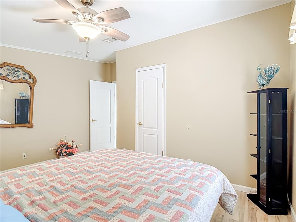 452 Par Drive Frostproof, FL 33843 - Photo 31 of 41 a bedroom with a bed and a chandelier