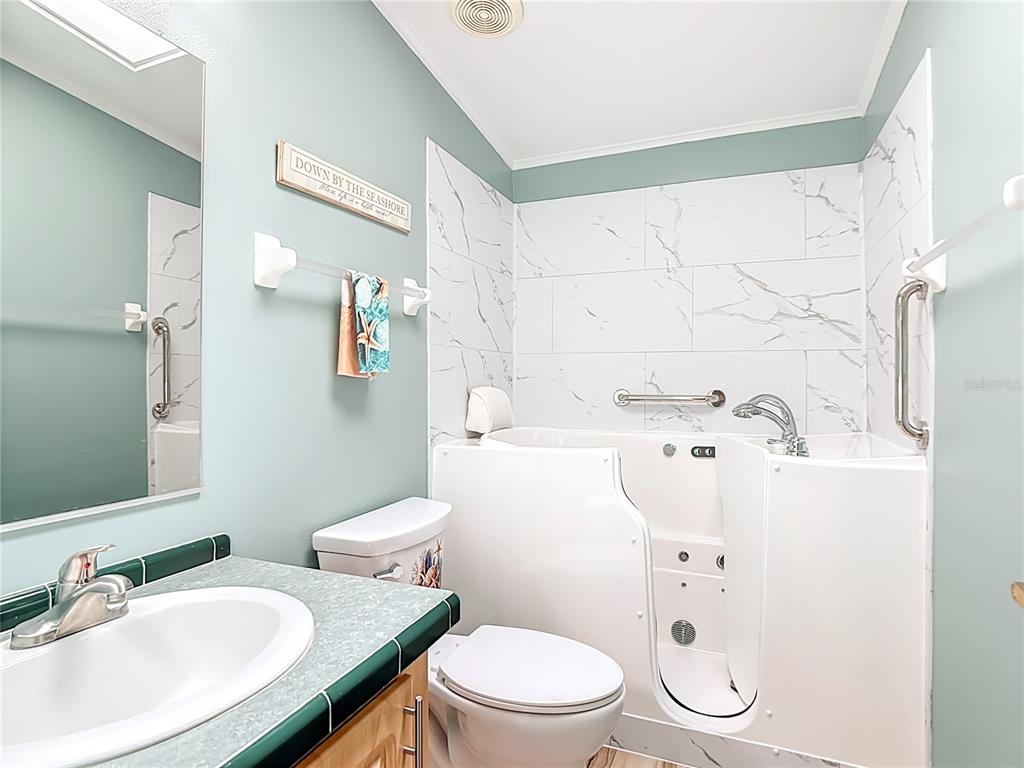 452 Par Drive Frostproof, FL 33843 - Photo 32 of 41 a bathroom with a sink a toilet and a mirror
