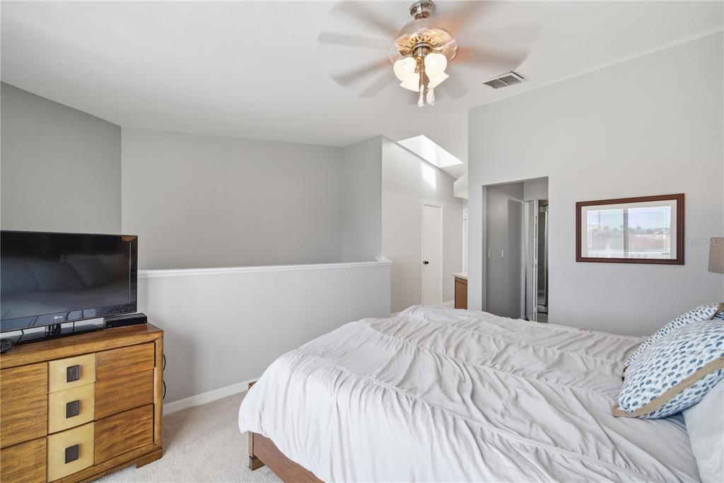 643 Garland Circle Indian Rocks Beach, FL 33785 - Photo 37 of 81 a bedroom with a bed and a flat screen tv