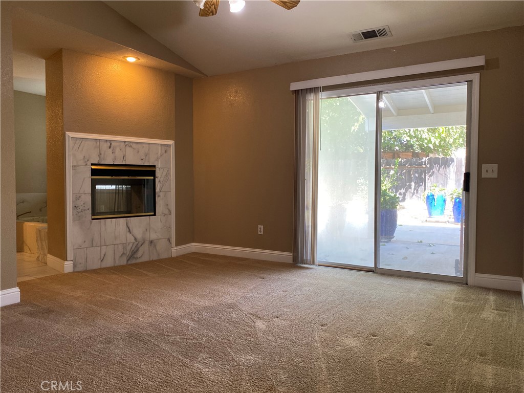 5409 Covert Road Salida, CA 95368 - Photo 12 of 23 a view of an empty room with a fireplace and a window