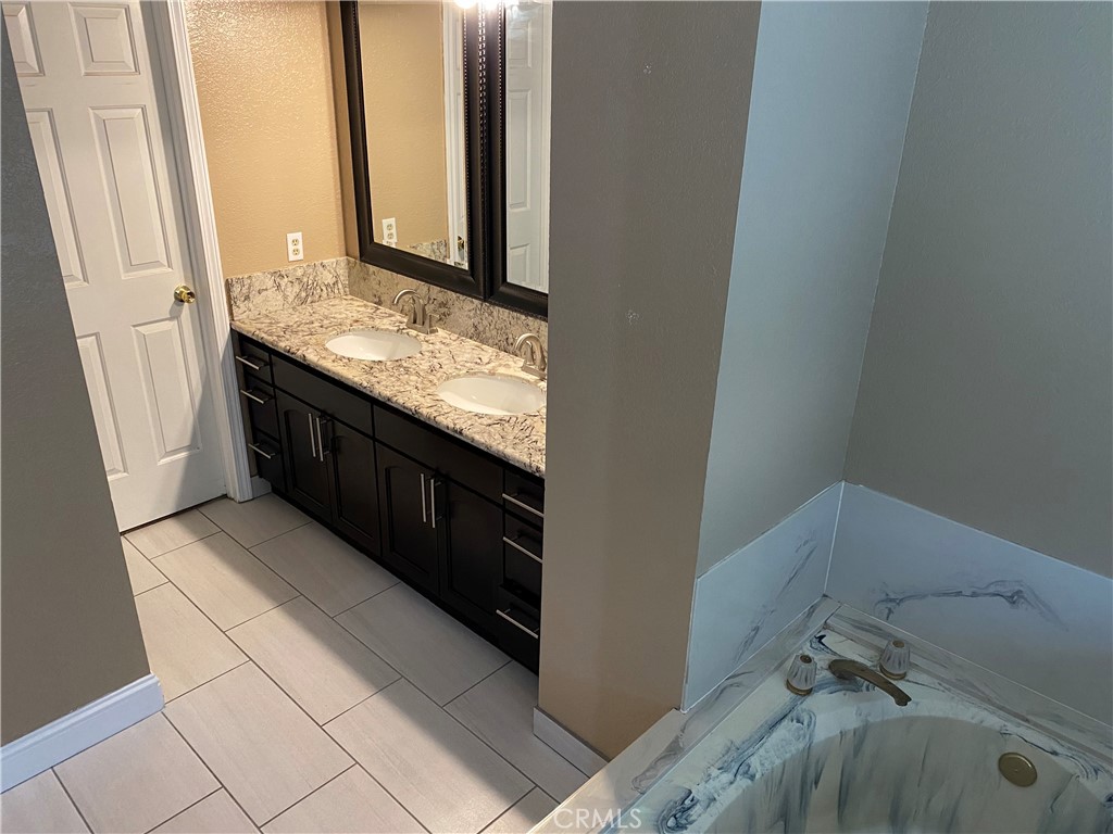 5409 Covert Road Salida, CA 95368 - Photo 16 of 23 a bathroom with a granite countertop sink and a mirror