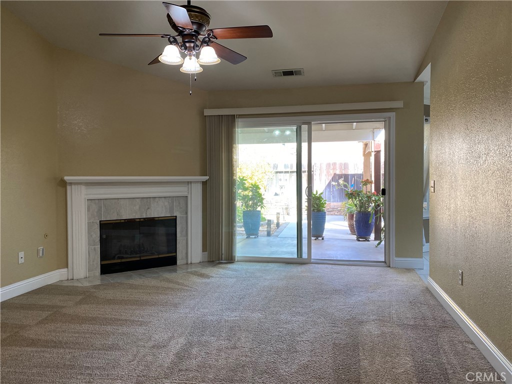 5409 Covert Road Salida, CA 95368 - Photo 5 of 23 a view of livingroom with fireplace fan and windows