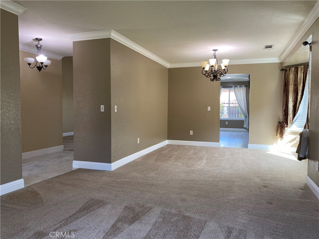 5409 Covert Road Salida, CA 95368 - Photo 8 of 23 an empty room with a chandelier fan and windows