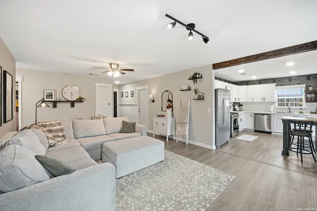 a living room with furniture and kitchen view