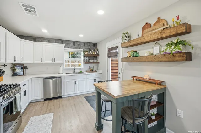 a open kitchen with a table and chairs
