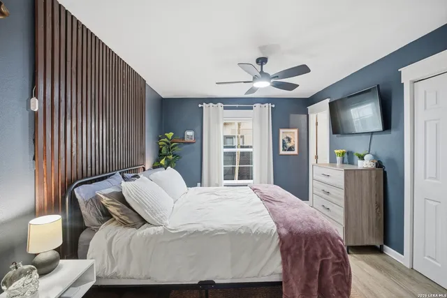 a bedroom with a bed and a flat screen tv