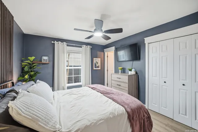 a bedroom with a large bed and a chandelier