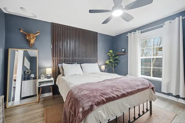 a bedroom with a large bed and a chandelier