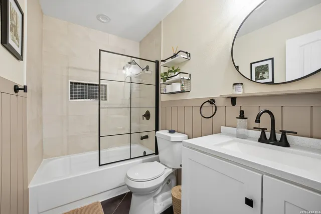 a bathroom with a sink toilet and shower