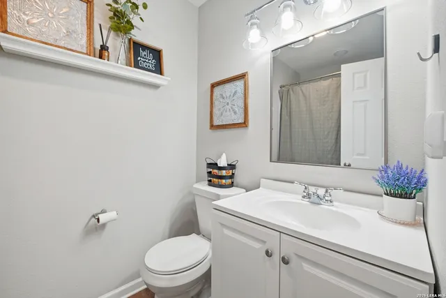 a bathroom with a sink toilet and a mirror