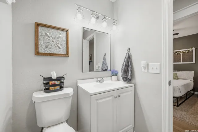 a bathroom with a toilet sink and mirror