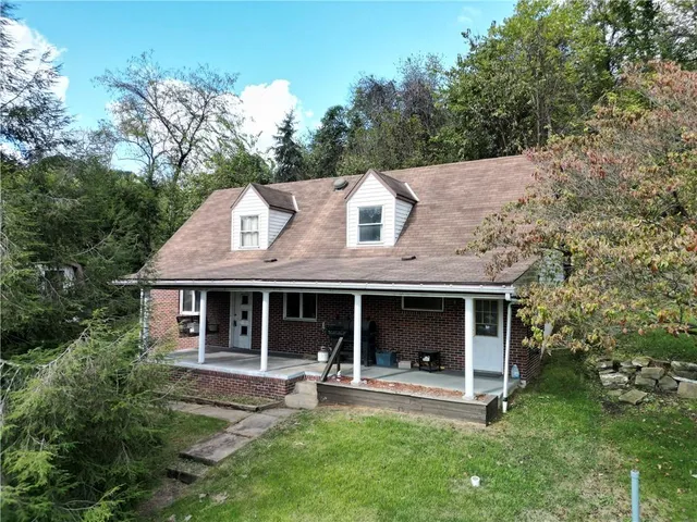 a front view of a house with a yard table and chairs