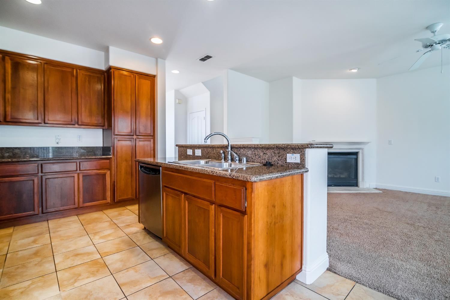 11737 Brook Valley Way Rancho Cordova, CA 95742 - Photo 19 of 25 a kitchen with stainless steel appliances granite countertop a sink and cabinets