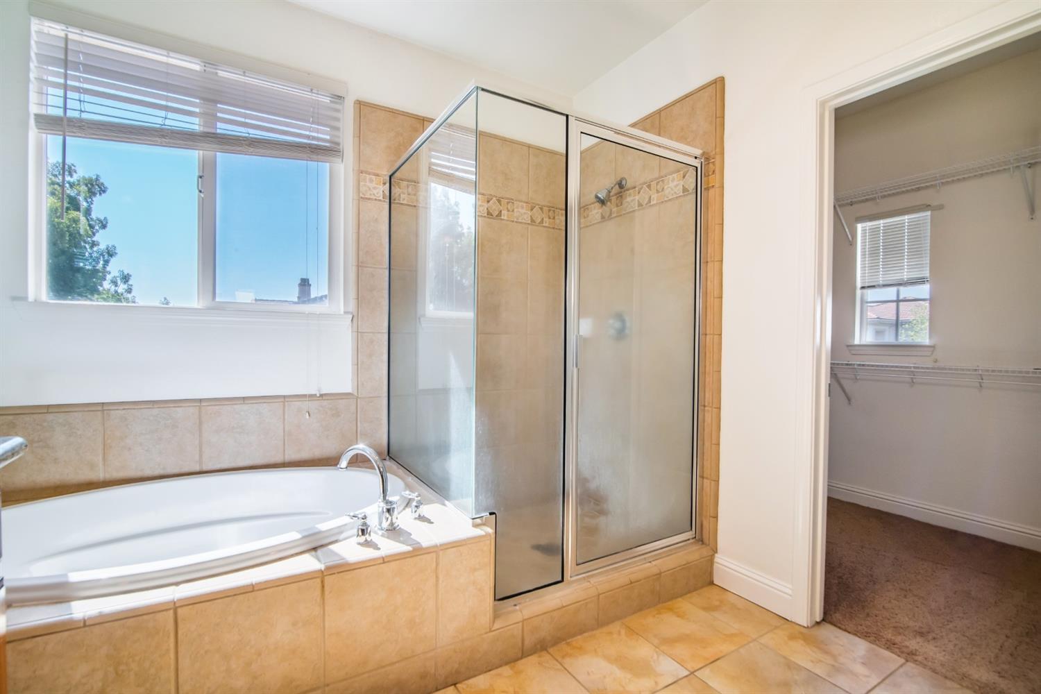 11737 Brook Valley Way Rancho Cordova, CA 95742 - Photo 20 of 25 a bathroom with a tub a sink and a mirror