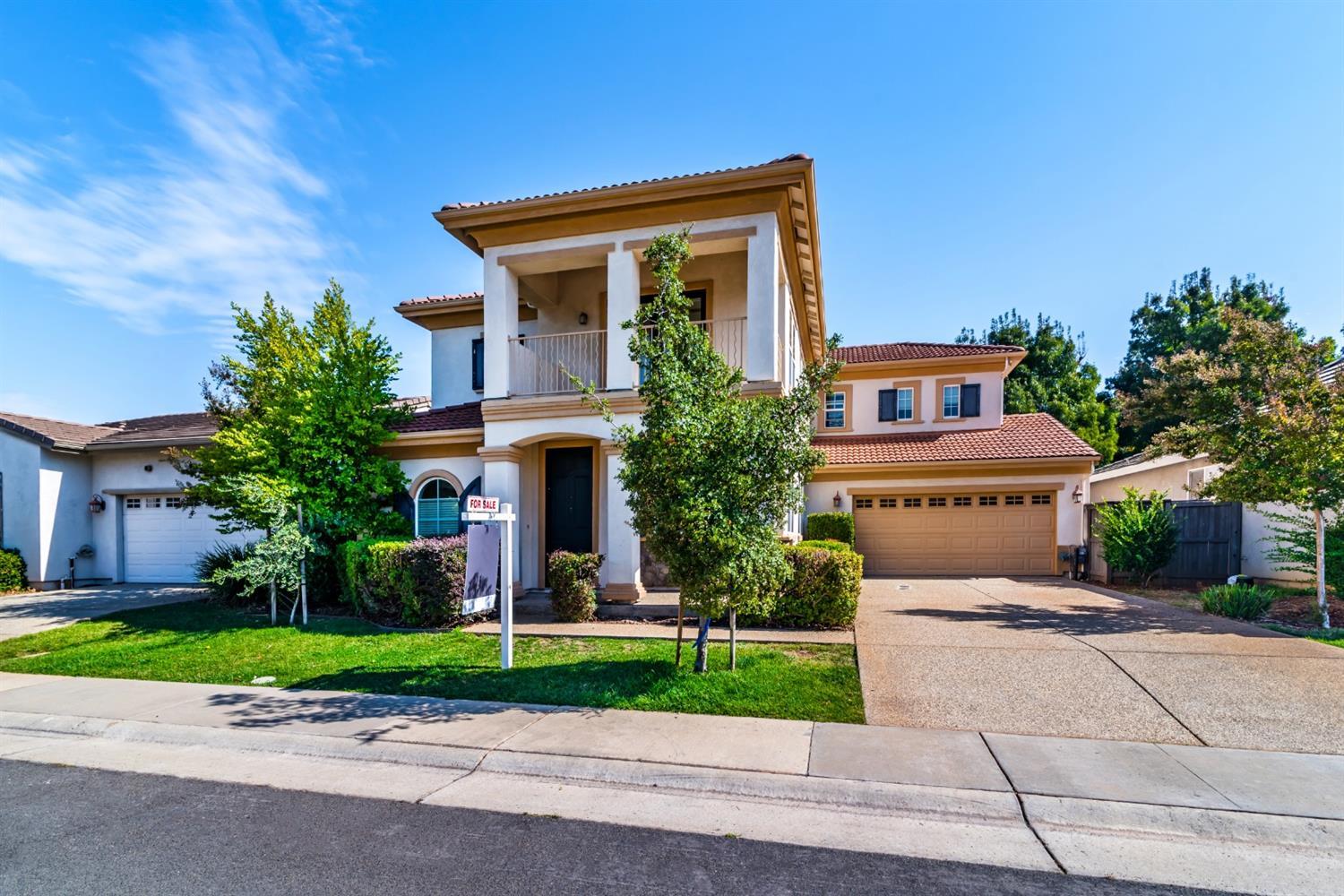 11737 Brook Valley Way Rancho Cordova, CA 95742 - Photo 2 of 25 a front view of a house with a yard and a garage