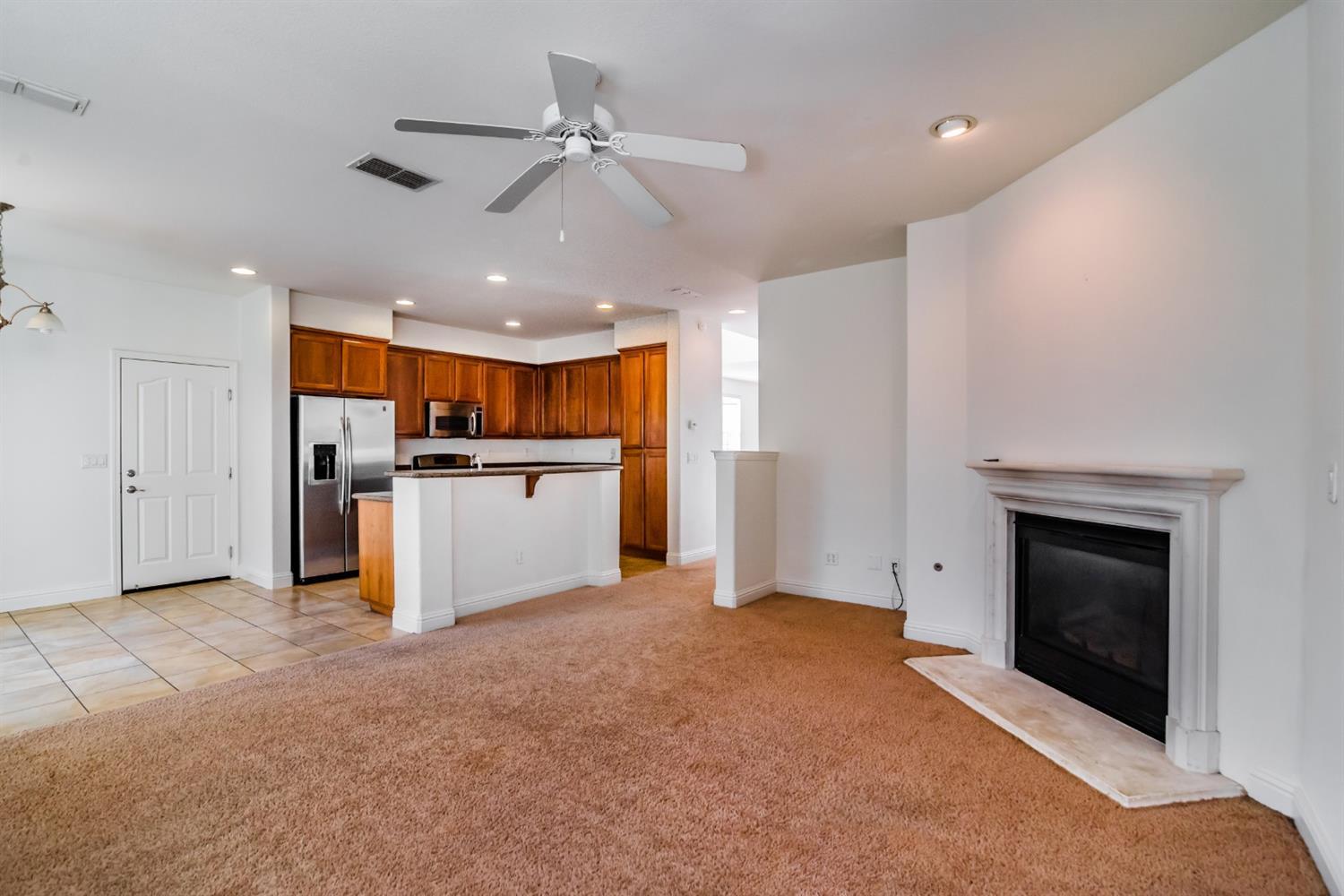 11737 Brook Valley Way Rancho Cordova, CA 95742 - Photo 23 of 25 a view of a kitchen with a sink and a fireplace