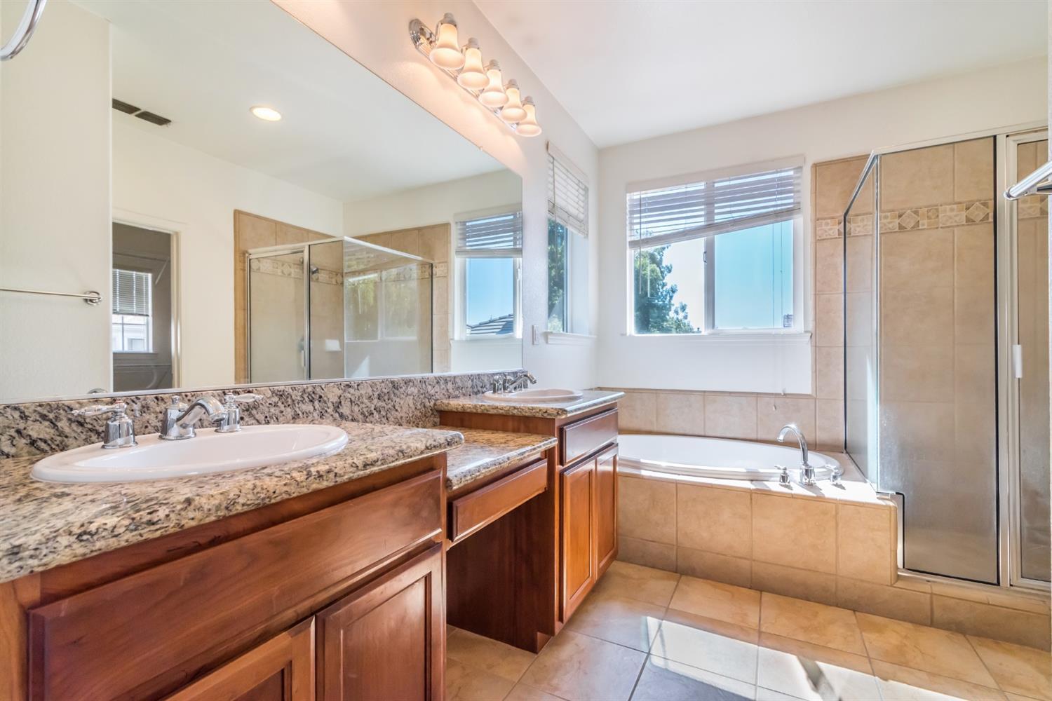 11737 Brook Valley Way Rancho Cordova, CA 95742 - Photo 5 of 25 a bathroom with a granite countertop sink mirror and a bath tub