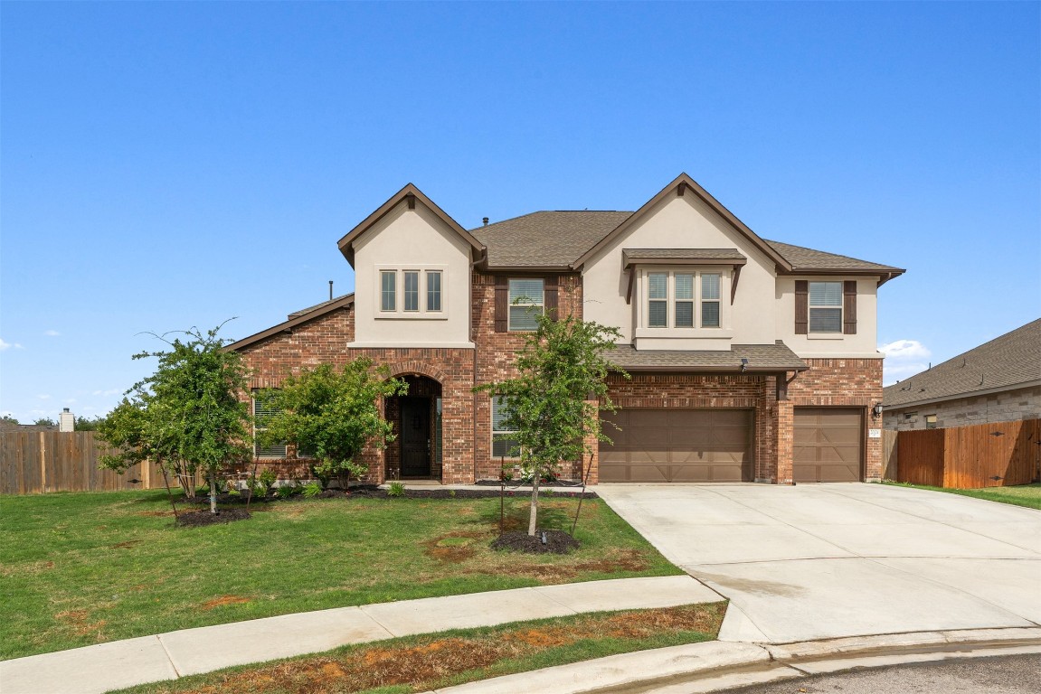 a front view of a house with a yard