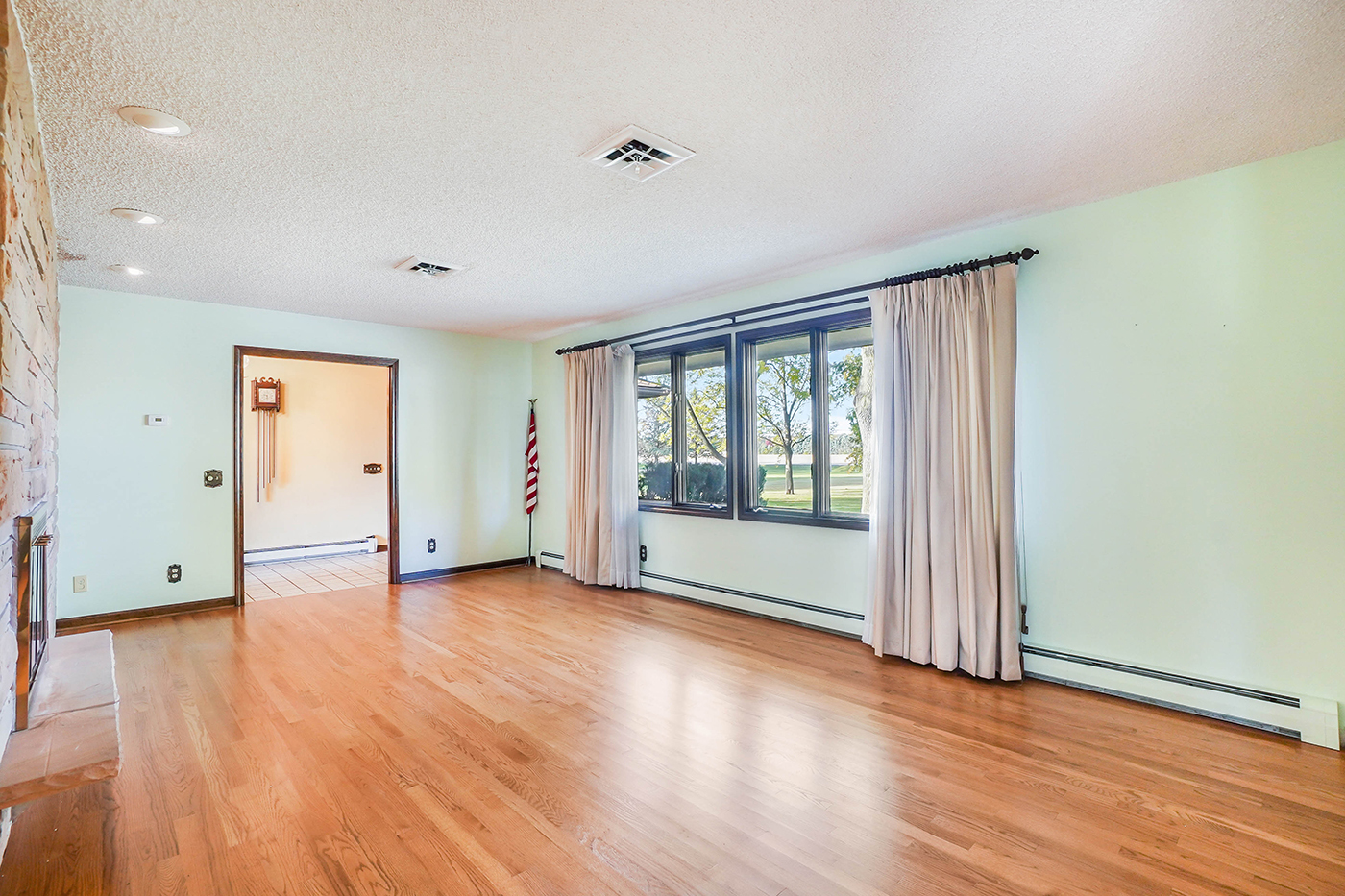 1850 Little Rock Road Plano, IL 60545 - Photo 5 of 30 a view of an empty room with wooden floor and a window