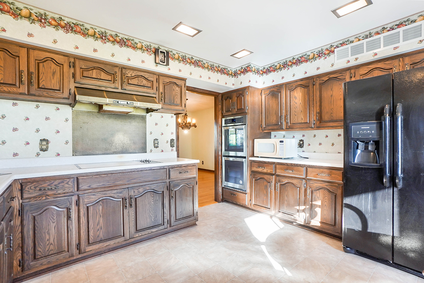 1850 Little Rock Road Plano, IL 60545 - Photo 9 of 30 a kitchen with stainless steel appliances granite countertop a refrigerator a oven and white cabinets with wooden floors